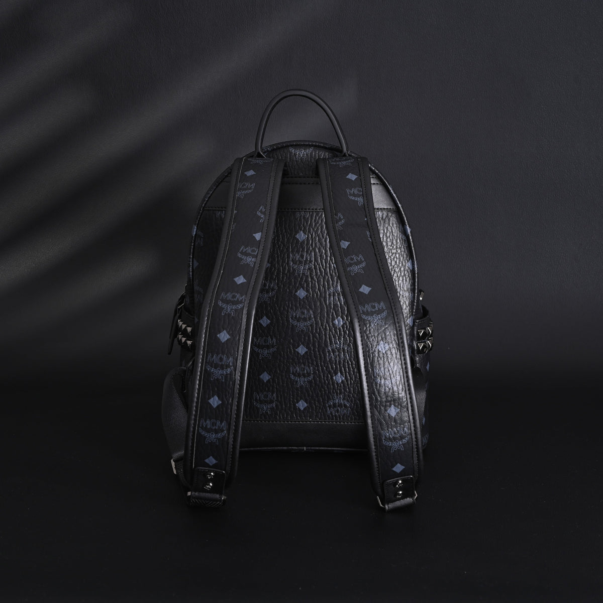 MCM Stark Visetos Medium Backpack – Black Monogram with Studded Detailing